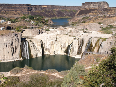 [A horseshoe-shaped falls area with a 200 foot drop of which nearly all of it was rock. There are several small streams of water falls across the rock, but most of the rock is dry.]